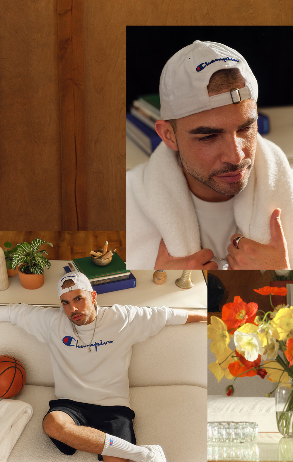 Man wearing Champion sweatshirt and cap in living room with flowers and books.