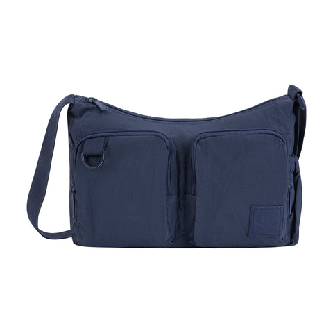 The Champion Quartz Small Messenger Bag is a navy blue nylon crossbody with two front zippered pockets, a top zipper, adjustable shoulder strap, functional design, and a small logo patch on the lower right front pocket.