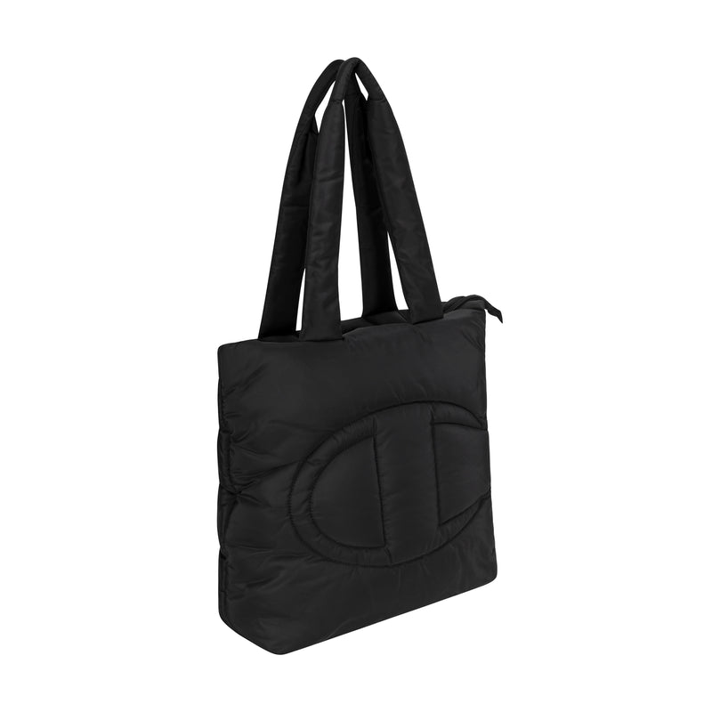 The Champion Quilted Billie Tote is a black bag with two long handles and a large stitched oval design on the front, ideal for everyday use. Photographed on a white background.