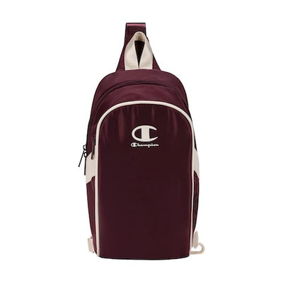 A maroon one-strap Champion sling backpack with white accents, featuring the Champion logo in white on the front pocket. The bag has a top handle and a zippered front compartment.