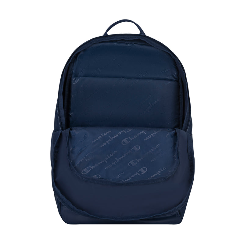 The Champion System Backpack in navy blue features multiple compartments, a front pocket with a subtle Champion logo pattern, and a padded laptop sleeve. It is shown against a white background.