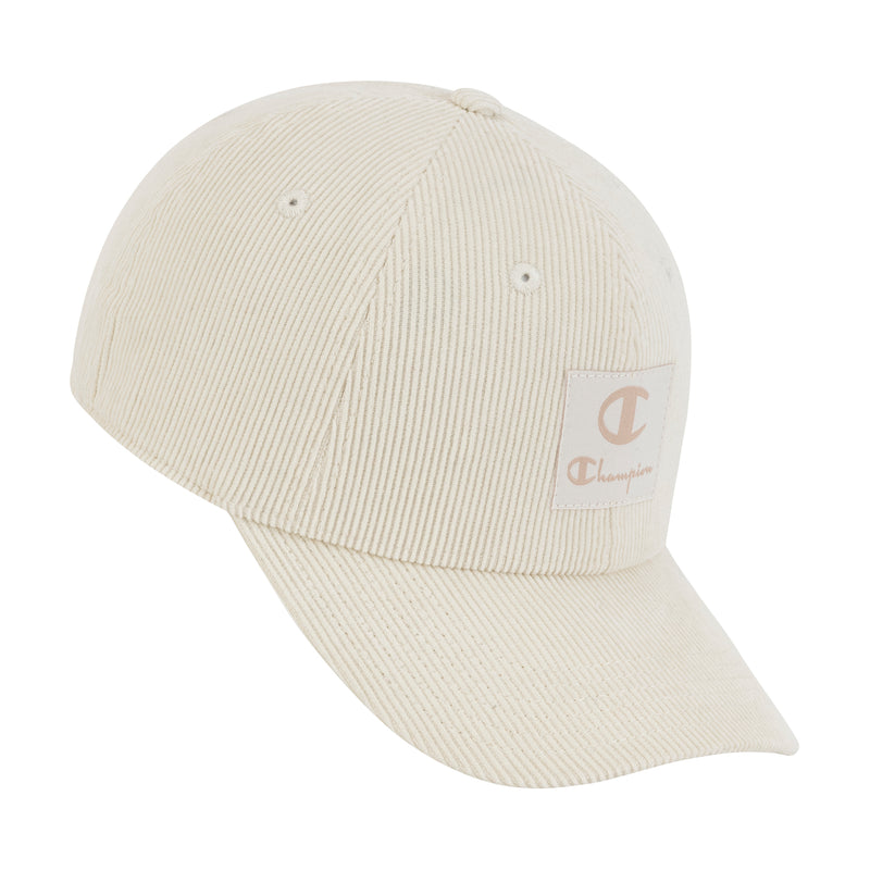 The Champion Ridge Corduroy Adjustable Cap features a cream ribbed corduroy design, curved brim, beige Champion logo patch on the front, and an adjustable back closure for comfort.