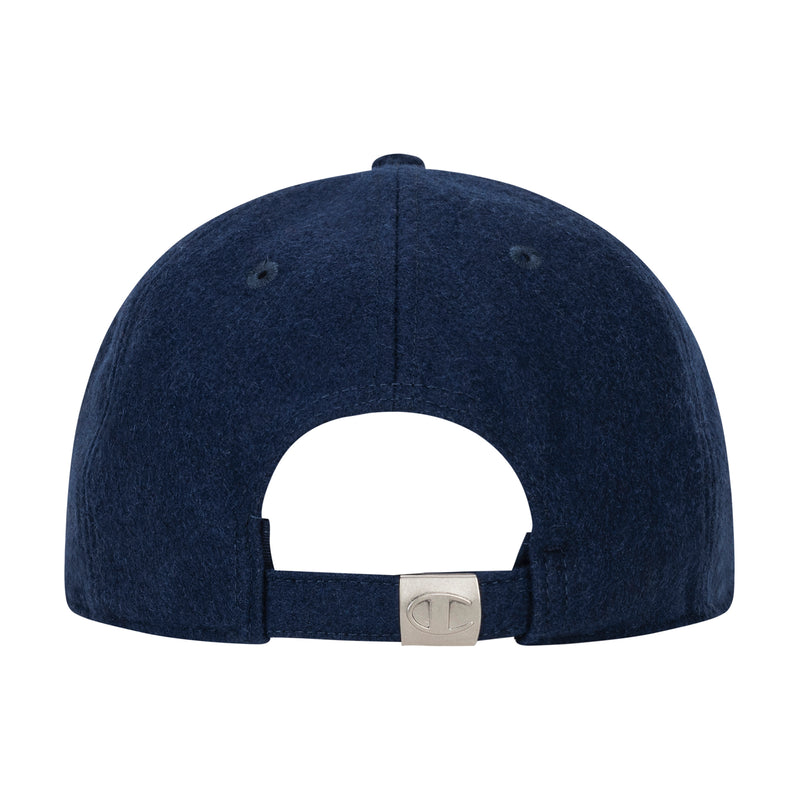 The Champion Sophomore Adjustable Cap is shown from the back, featuring a navy blue unconstructed design and an adjustable strap with a metal clasp engraved with "C" for classic collegiate style.