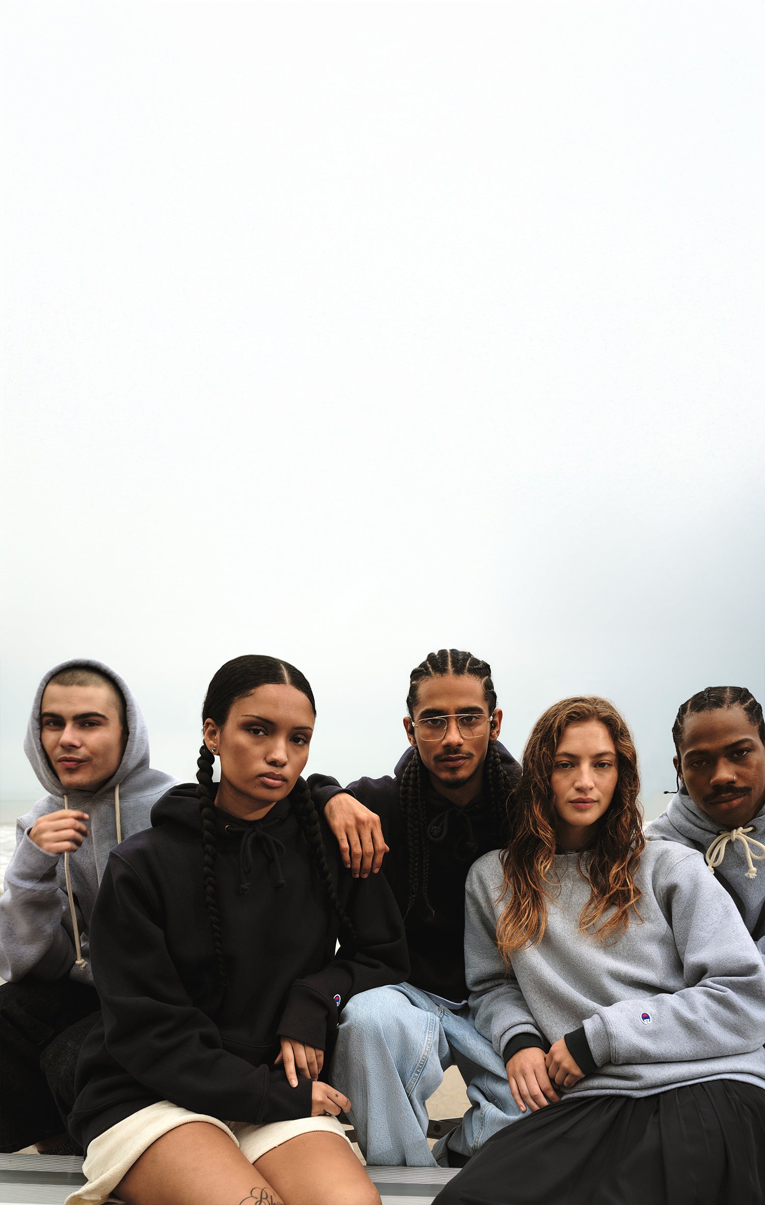 Five people sitting together on a white background