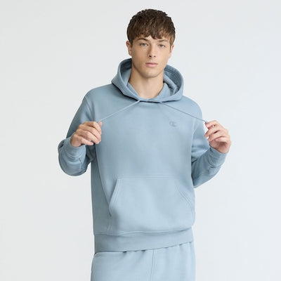 A man holding a string of a blue sweatshirt.